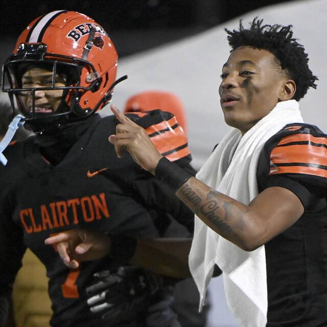 Clairton quarterback Jeff Thompson celebrates with Tahvaz Armstrong as time winds down in the Bears’ PIAA Class A semifinal against Greenville on Friday, Nov. 28, 2025, at Helling Stadium in Ellwood City. (Christopher Horner | TribLive)