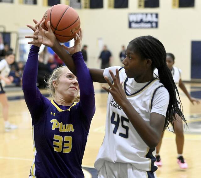 Plum’s Riley Stephans is fouled by Kiski Area’s Alaysia Bell during their game on Monday, Dec. 8, 2025, at Kiski Area. (Christopher Horner | TribLive)