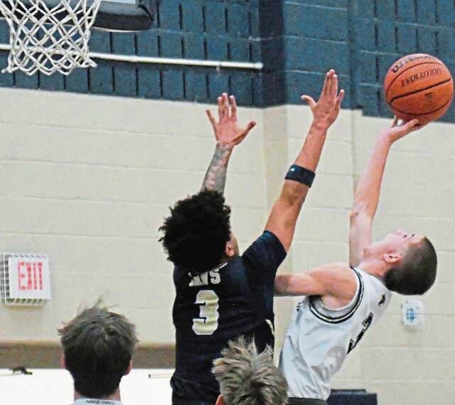 Franklin Regional's Webber Rankin goes up over Kiski Area's Amaree Gonzalez during their game Tuesday, Dec. 9, 2025. (Paul Schofield | TribLive)
