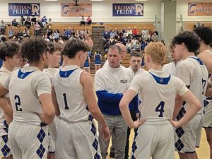Derry players listen to coach Tom Esposito (center) during a timeout against Connellsville on Tuesday night. (Bill Beckner | TribLive)