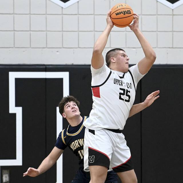 Upper St. Clair’s Ryan Robbins grabs a rebound over Norwin’s Josh Lenart during their game on Tuesday, Dec. 9, 2025, at USC. (Christopher Horner | TribLive)
