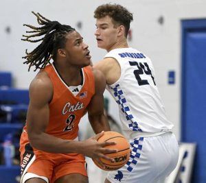 Latrobe’s Rob Young works past Hempfield’s Luke Williams on Dec. 4. (Christopher Horner | TribLive)