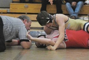 Franklin Regional's Titus Colangelo pins Moon’s Landon Lower at 127 pounds Wednesday, Dec. 10, 2025. (Paul Schofield | TribLive)