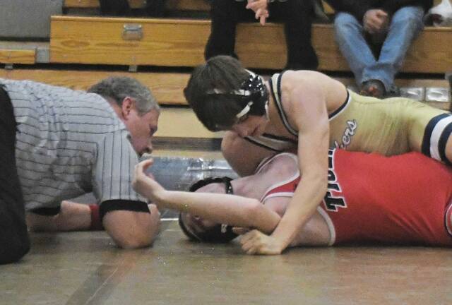 Franklin Regional's Titus Colangelo pins Moon’s Landon Lower at 127 pounds Wednesday, Dec. 10, 2025. (Paul Schofield | TribLive)