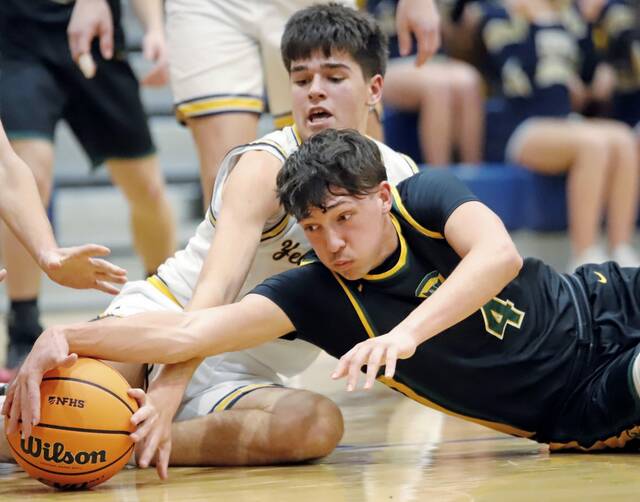 Deer Lakes’ Luca Mangieri (4) fights for the ball against Freeport on Friday. (Josh Rizzo | For TribLive)