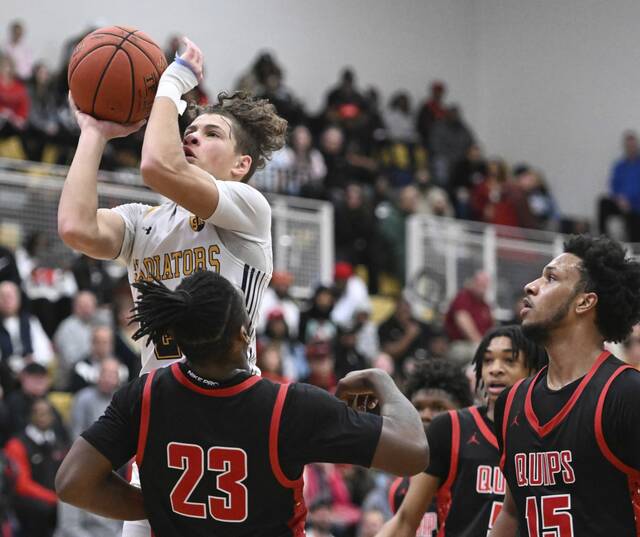 South Allegheny’s Drew Cook drives over Aliquippa’s Cleaster Longmire IV during the PIAA Class 3A semifinals March 22. (Chaz Palla | TribLive)