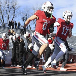 Peters Twp.’s Lucas Shanafelt and Nolan DiLucia take the field before the start of their PIAA Class 5A state semifinal against Bishop McDevitt on Saturday, Nov. 29, 2025, at Mansion Park in Altoona. (Christopher Horner | TribLive)