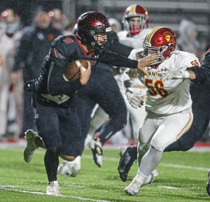 Elizabeth Forward’s Ryan Messina stiff-arms North Catholic’s Max Lindner in a WPIAL Class 3A quarterfinal Friday, Nov. 7, 2025. (Mike Darnay | Mon Valley Independent)