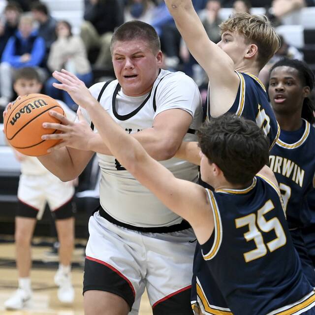 Upper St. Clair’s Ryan Robbins fends off Norwin defenders during their game on Tuesday, Dec. 9, 2025, at USC. (Christopher Horner | TribLive)