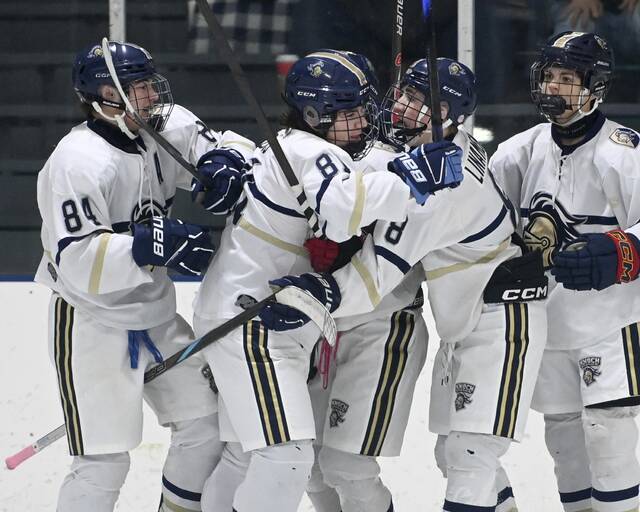 Knoch’s Drew Ross (81) celebrates with Brady Linamen after scoring against Burrell on Monday, Dec. 15, 2025, at Frozen Pond. (Christopher Horner | TribLive)
