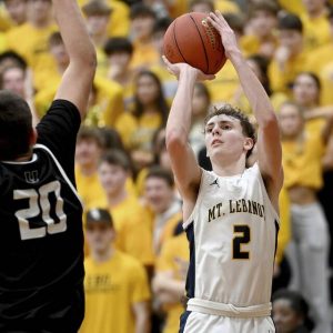 Mt. Lebanons Liam Sheely scores against Upper St. Clairs Tyler Robbins on Feb. 2, 2024. (Christopher Horner | TribLive)