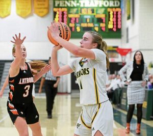 Penn-Traffords Izzy Fontana shoots a 3-pointer next to Latrobes Brianna Havrilla on Tuesday, Dec. 16, 2025, at Penn-Trafford. (Christopher Horner | TribLive)