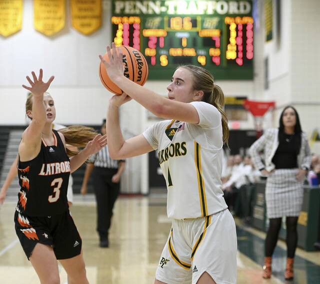 Penn-Traffords Izzy Fontana shoots a 3-pointer next to Latrobes Brianna Havrilla on Tuesday, Dec. 16, 2025, at Penn-Trafford. (Christopher Horner | TribLive)