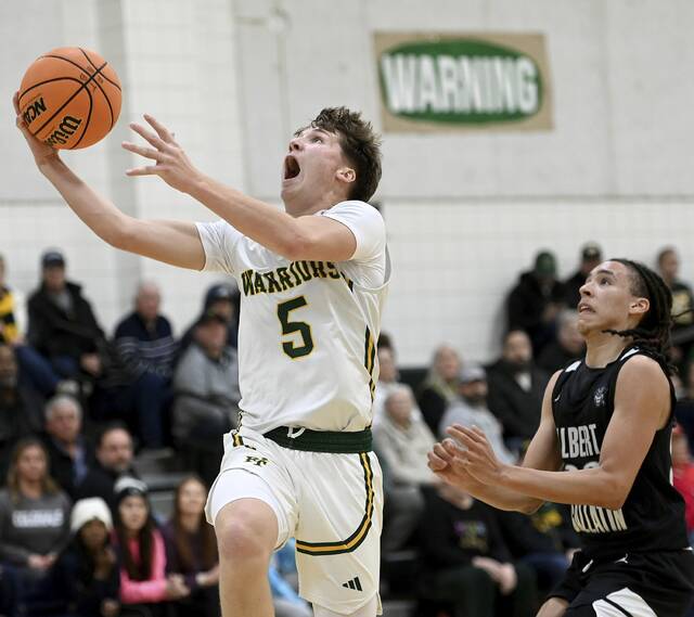Penn-Traffords Trent Brown scores past Albert Gallatins Darrin Ford on Tuesday at Penn-Trafford. (Christopher Horner | TribLive)