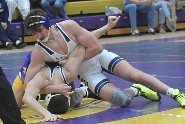 Norwins Noah Curran tries to turn Plums Owen Campbell at 152 pounds Wednesday. (Paul Schofield | TribLive)