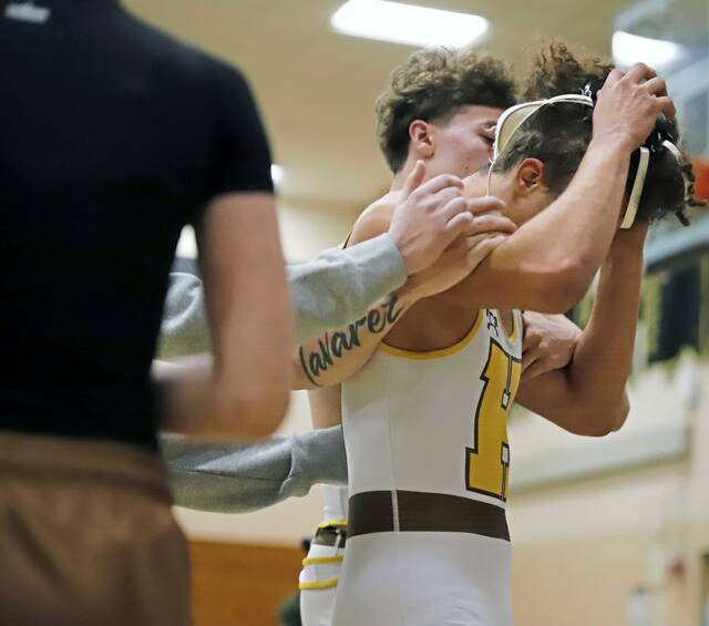 Highlands Taiyvon Partlow is escorted back to the locker room by teammates after his 172-pound match was stopped following a scuffle between both teams Wednesday, Dec. 17, 2025, at Valley High School. (Josh Rizzo | For TribLive)