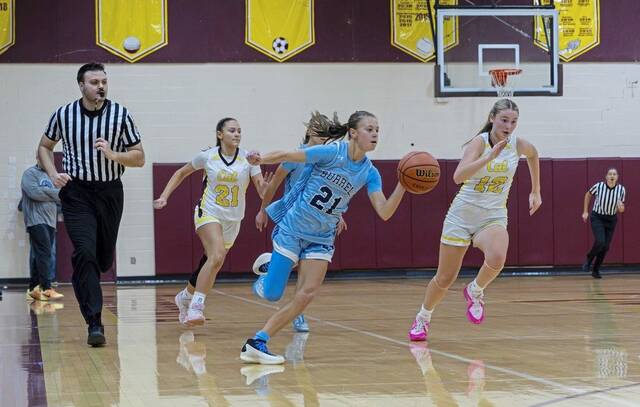 Burrells Chase Coury brings the ball upcourt against California during a Dec. 4 game. (Floyd Kish | Mon Valley Independent)