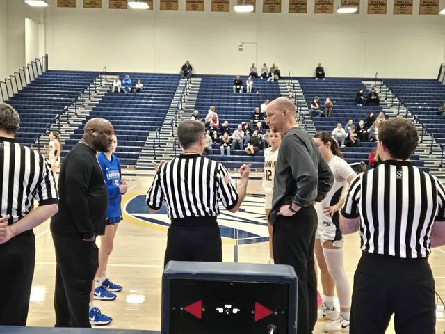 Norwin and Connellsville players and coaches meet with officials before Thursday night's game in North Huntingdon.