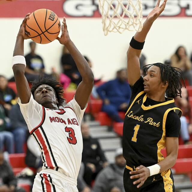 Moons AJ Buford scores against Lincoln Parks Antonio Goodman on Dec. 10. (Christopher Horner | TribLive)
