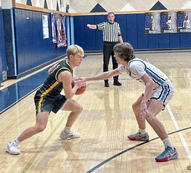 Deer Lakes Collin Rodgers drives against Burrells Sam Conte on Friday. (Antonio Rossetti | For TribLive)