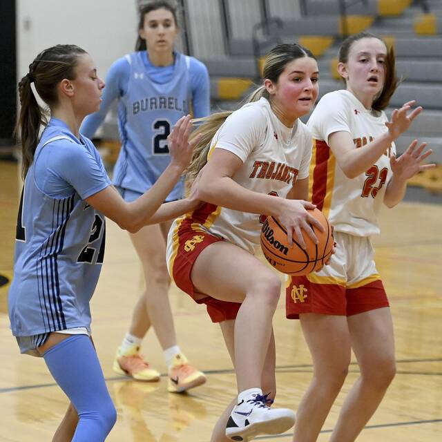 North Catholic’s Finley O’Shea pulls down a rebound next to Burrell’s Chase Coury on Monday, Dec. 22, 2025, in Cranberry. (Christopher Horner | TribLive)