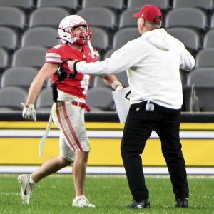 Avonworths Luca Neal celebrates with coach Duke Johncour after scoring against Imani Christian during the WPIAL Class 3A championship game Nov. 22, 2025, at Acrisure Stadium. (Christopher Horner | TribLive)