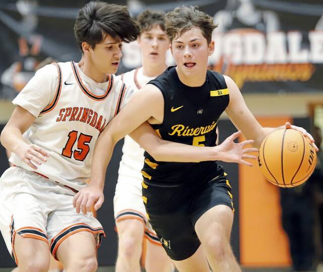 Springdale's Landon Linderman attempts to knock the ball away from Riverview's Rex Roberts on Tuesday, Dec. 23, 2025, at Donald McGhee Fieldhouse. (Josh Rizzo | For TribLive)