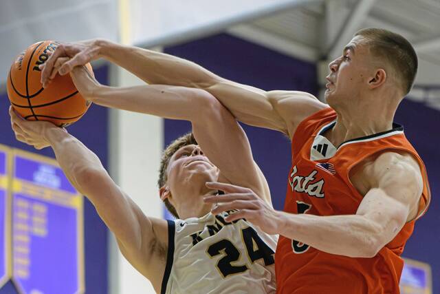 Knoch's Liam Avon (24) attempts a shot amidst heavy pressure from Latrobe's Ian DeCerb (5) on Friday, Dec. 26, 2025, at Plum. (Andrew Palla | For TribLive)