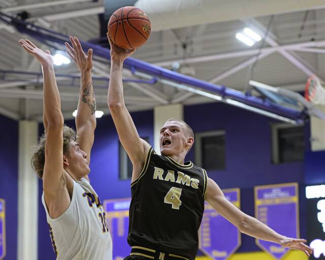 Highlands Troy Bielak (4) attempts a shot over Plums Owen Proskin (10) on Friday at Plum. (Andrew Palla | For TribLive)