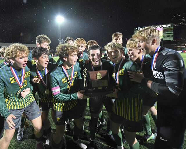 The Deer Lakes boys soccer team celebrates with the WPIAL championship trophy after defeating Beaver, 3-2, in the Class 2A final on Wednesday, Oct. 209 2025, at Highmark Stadium. (Christopher Horner | TribLive)
