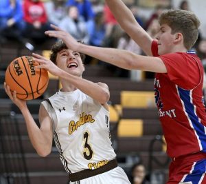 Greensburg Salems Ty Harkcom drives to the basket against Mt. Pleasants Raymond Arrigo on Monday at Greensburg Salem. (Christopher Horner | TribLive)