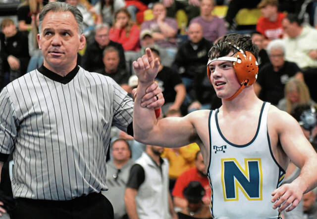 Norwin sophomore Landon Sidun gets his hand raised after winning his second Powerade Tournament title last year. (Paul Schofield | TribLive)