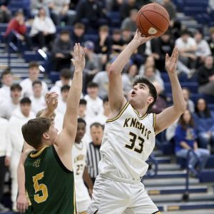Norwins Stef Giannikas scores over Penn-Traffords Trent Brown on Dec. 2. (Christopher Horner | TribLive)