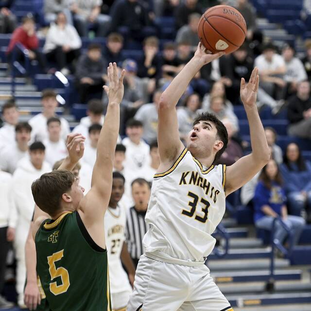 Norwins Stef Giannikas scores over Penn-Traffords Trent Brown on Dec. 2. (Christopher Horner | TribLive)