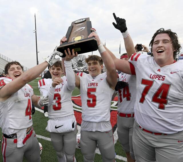 Avonworth captains celebrate after receiving the state championship trophy after defeating Northwestern Lehigh in the PIAA Class 3A final Dec. 6, 2025, at Cumberland Valley. (Christopher Horner | TribLive)