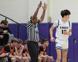 Knochs Roman DeFelice (13) gets back on defense after nailing a 3-pointer in front of the Latrobe bench on Dec. 26, 2025, at Plum. (Andrew Palla | For TribLive)