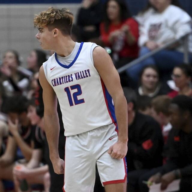 Chartiers Valleys Julian Semplice celebrates a 3-pointer in front of the Moon bench on Dec. 19, 2025. (Christopher Horner | TribLive)