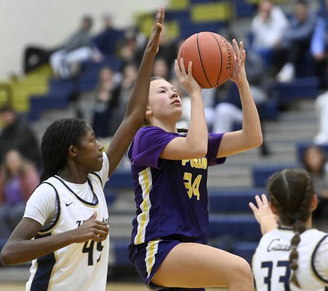 Plum’s Tori Glogowski drives past Kiski Area’s Alaysia Bell during their game on Monday, Dec. 8, 2025, at Kiski Area. (Christopher Horner | TribLive)
