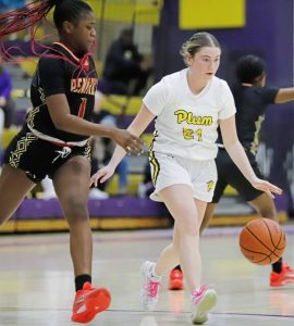 Plum guard Taylie Auth dribbles across the lane to try and elude Penn Hills Malaya Middleton on Monday at Plum High School. Auth scored a team-high 14 points, and the Mustangs won 45-39. (Josh Rizzo | For TribLive)