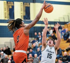 Latrobe’s Rob Young blocks a shot by Franklin Regional’s Anthony Mitchell on Tuesday, Jan. 6, 2026 in Murrysville. (Christopher Horner | TribLive)