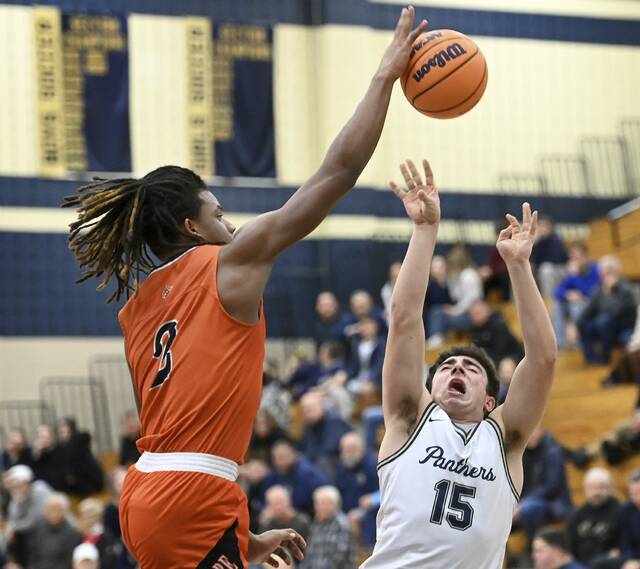 Latrobe’s Rob Young blocks a shot by Franklin Regional’s Anthony Mitchell on Tuesday, Jan. 6, 2026 in Murrysville. (Christopher Horner | TribLive)