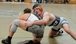 Norwins Landon Sidun gets a takedown against Penn-Traffords Dylan Barrett in the 121-pound match Jan. 7. (Paul Schofield | TribLive)