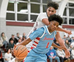 Jeannettes Kymone Brown takes the ball from Greensburg Central Catholics Carson Kramer on Friday. (Chaz Palla | TribLive)