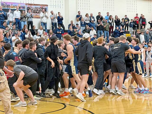 Knoch players and fans celebrate the boys basketball teams victory over North Catholic on Friday. (Antonio Rossetti | For TribLive)