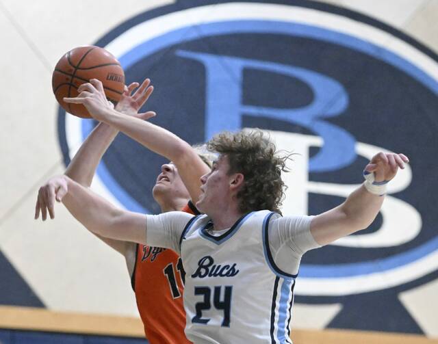 Burrell’s Ryan Wass defends on Springdales’ Trevor Clark Friday Dec. 5, 2025 at Burrell High School. (Chaz Palla | TribLive)