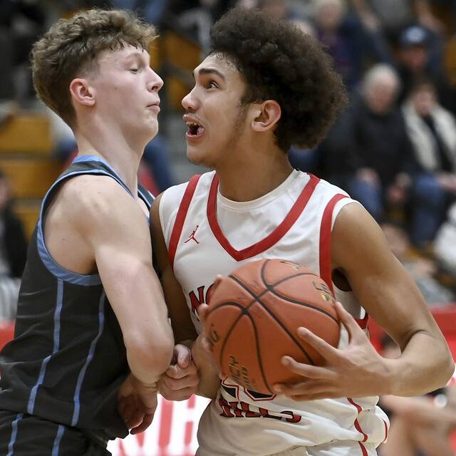 North Hills Nathan Schanbacher drives to the basket against Seneca Valleys Andrew Omasits on Jan. 24, 2025. (Christopher Horner | TribLive)