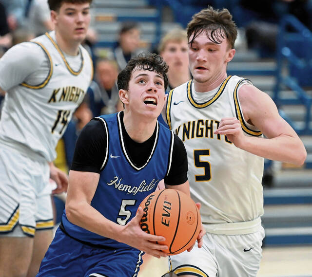 Hempfields Trevor Donsen drives to the basket past Norwins Alex Graney during their game on Tuesday at Norwin. (Christopher Horner | TribLive)