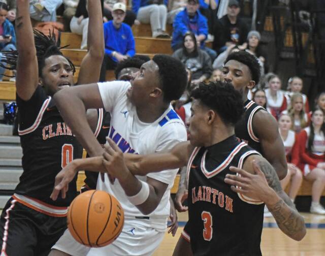 Jeannettes Markus McGowan is fouled by Clairtons Jeff Thompson III during a Section 1-2A game Tuesday, Jan. 13, 2026. (Paul Schofield | TribLive)