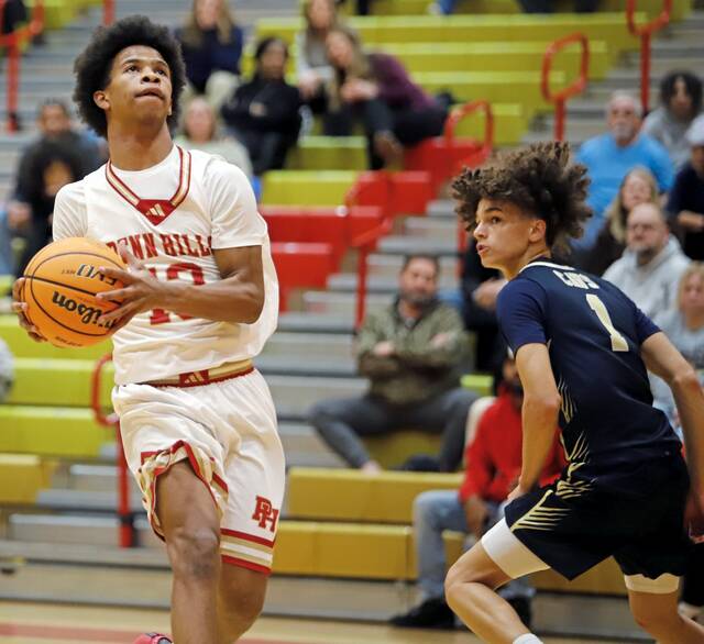 Penn Hills' Darian Robinson drives toward the rim as Kiski Area's DJ Lindenfelser looks on Tuesday, Jan. 13, 2026 at Penn Hills. (Josh Rizzo | For TribLive)