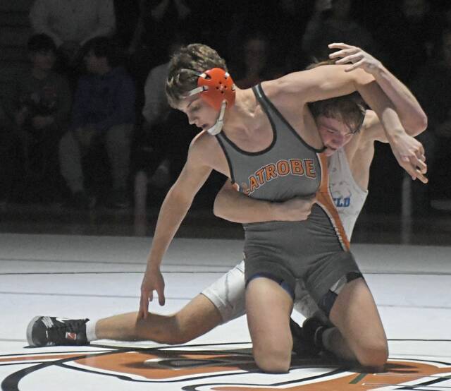 Latrobes Logan Peagler tries to escape the hold of Hempfields Murphy Sheridan at 139 pounds Wednesday. (Paul Schofield | TribLive)